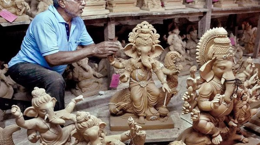 The image shows a clay Ganesha idol in the making in Goa